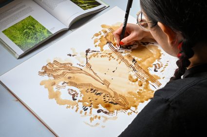 artist residency at the Sou'Wester, woman painting in vintage trailer